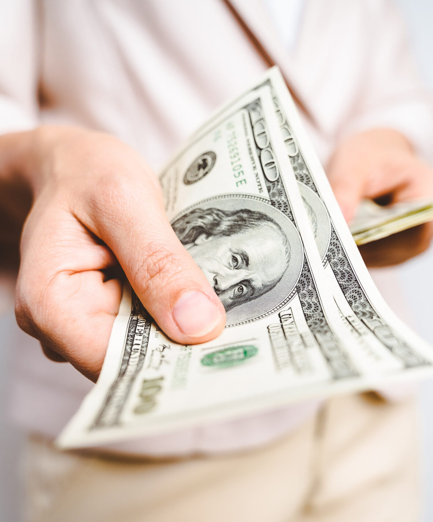 Home closeup of business woman hands proposing money us dollar bills